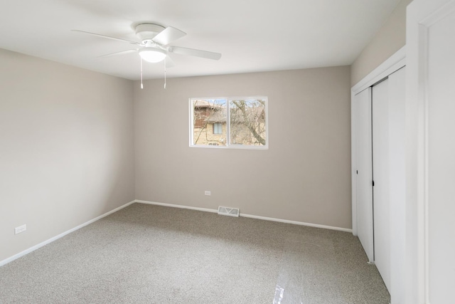 unfurnished bedroom with ceiling fan, a closet, and carpet