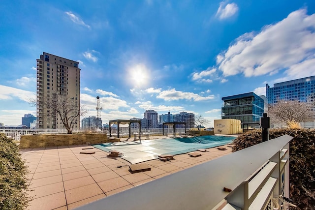 view of pool featuring a patio area and a city view