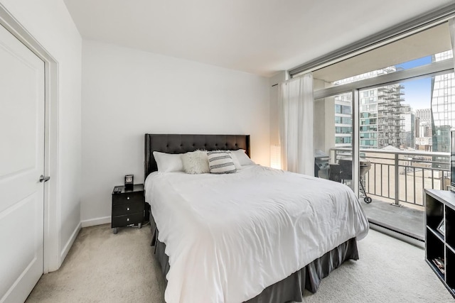 carpeted bedroom featuring access to exterior, a view of city, and baseboards