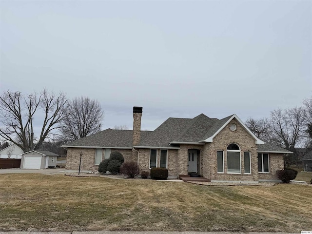 single story home featuring an outdoor structure, brick siding, a garage, and a chimney