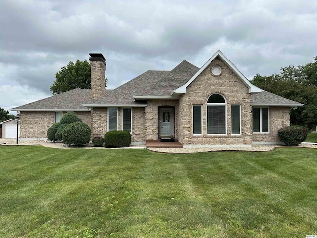 1501 Gayla Dr, Quincy, IL 62305 - view of front facade featuring brick siding, a shingled roof, a front yard, and a chimney