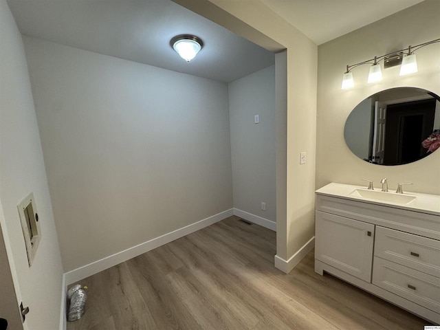 bathroom with hardwood / wood-style flooring and vanity