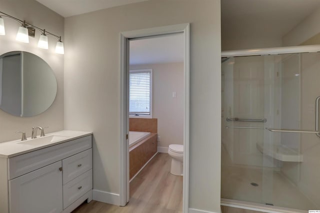 1501 Gayla Dr, Quincy, IL 62305 - full bathroom with wood finished floors, vanity, a shower stall, and a garden tub