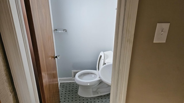 bathroom featuring visible vents, toilet, and baseboards