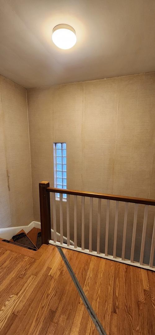 stairway featuring wood finished floors