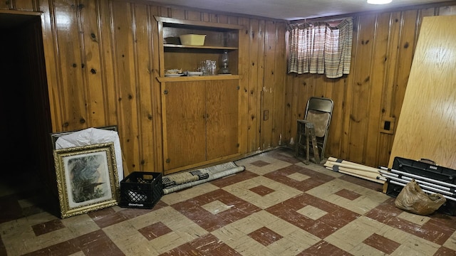 interior space featuring dark floors and wood walls