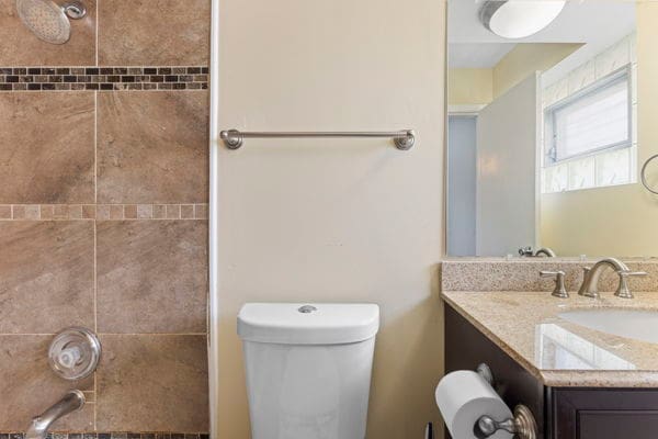 full bathroom featuring toilet and vanity
