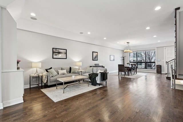 living room featuring dark hardwood / wood-style floors and a notable chandelier