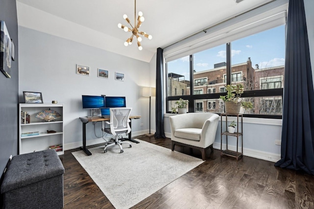 home office with an inviting chandelier and dark hardwood / wood-style floors