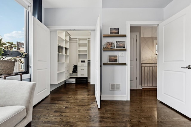 interior space with dark hardwood / wood-style floors and a closet