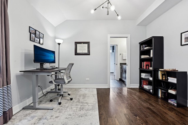 office space featuring hardwood / wood-style floors, vaulted ceiling, and a chandelier