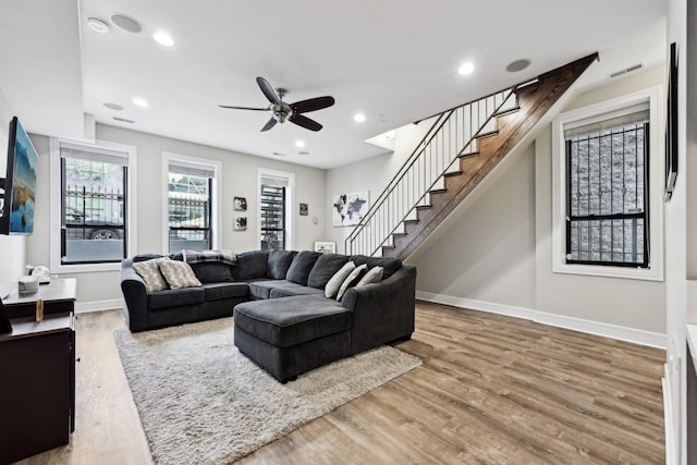 living room with hardwood / wood-style floors and ceiling fan