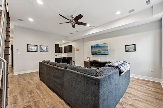 living room with ceiling fan and light hardwood / wood-style floors