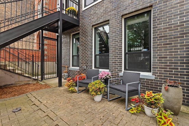 doorway to property featuring a balcony and a patio area