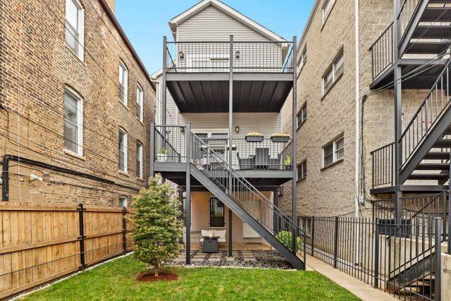 rear view of property with a yard