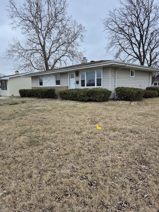 ranch-style home with a front lawn