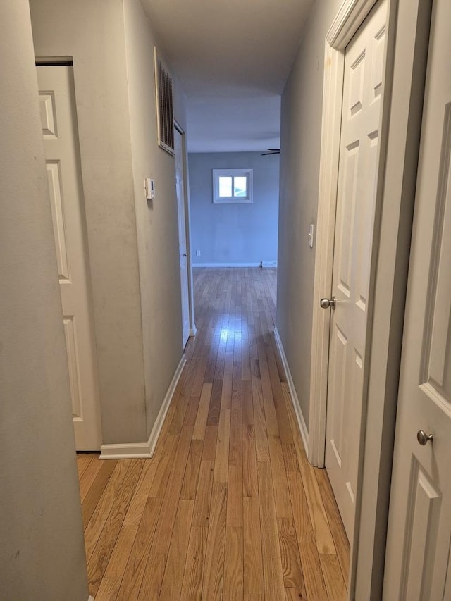 hall with light hardwood / wood-style floors