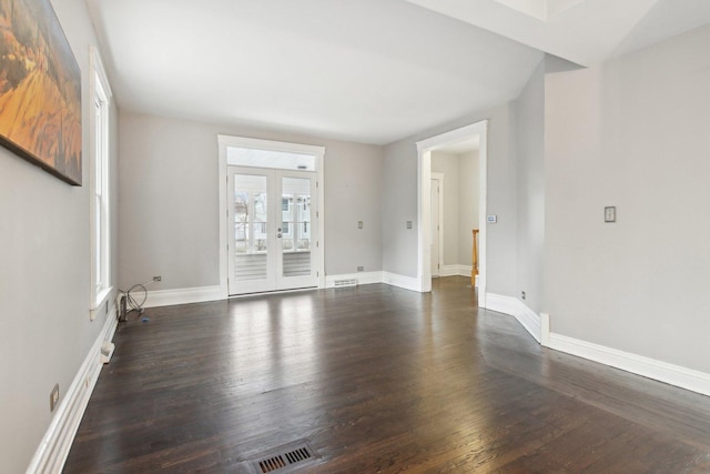 empty room featuring dark hardwood / wood-style floors and french doors