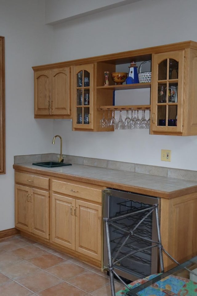 bar with light tile patterned flooring, sink, and wine cooler