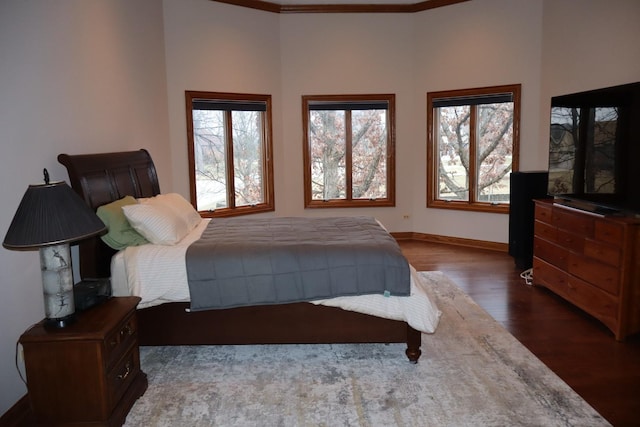 bedroom with dark wood-type flooring