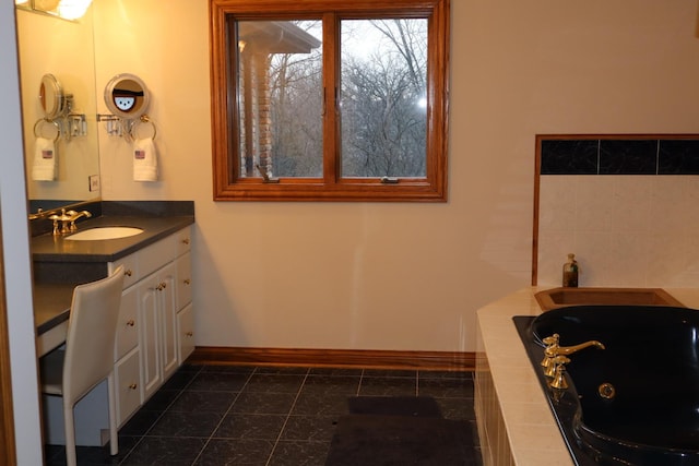 bathroom featuring vanity and a tub