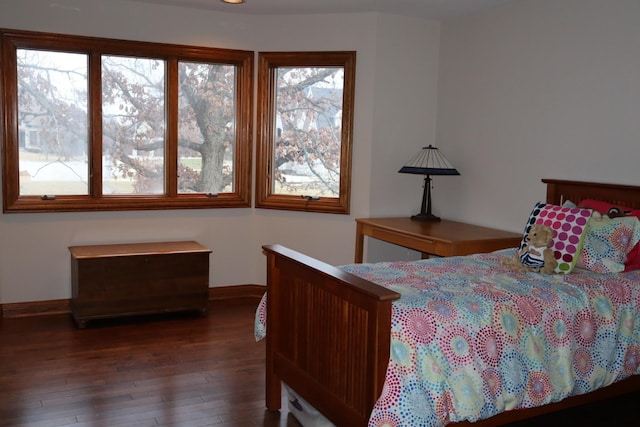 bedroom with dark hardwood / wood-style flooring