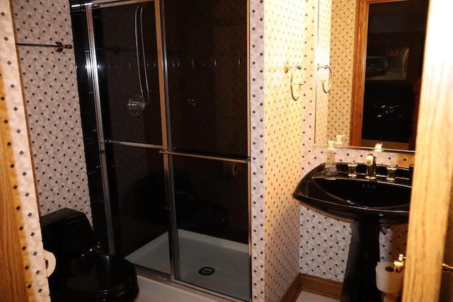 bathroom with an enclosed shower and sink