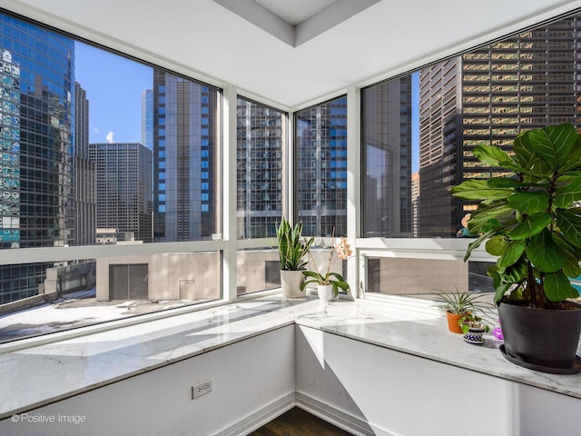 unfurnished sunroom with a city view