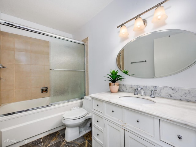 bathroom featuring enclosed tub / shower combo, vanity, and toilet