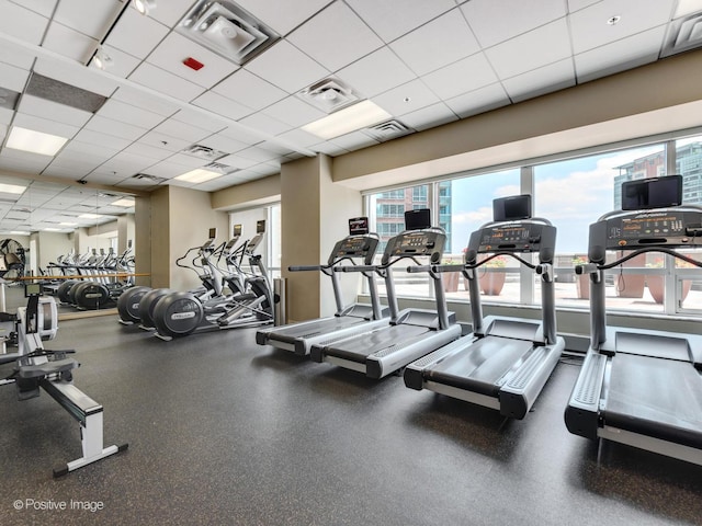 workout area with a paneled ceiling and visible vents