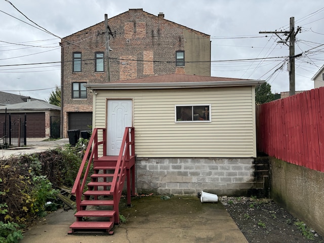 back of house with a garage and an outdoor structure