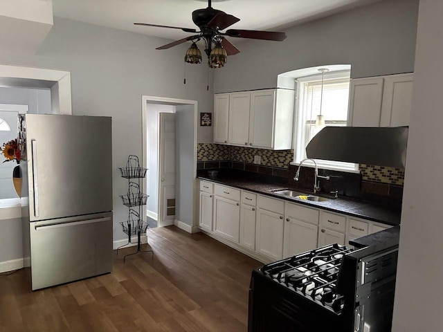 2245 W 23rd St, Chicago, IL 60608 - kitchen featuring freestanding refrigerator, a sink, dark countertops, and ceiling fan