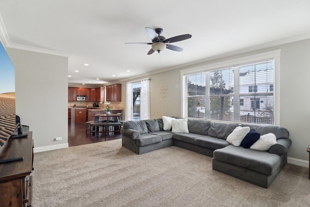 carpeted living room featuring ceiling fan and ornamental molding