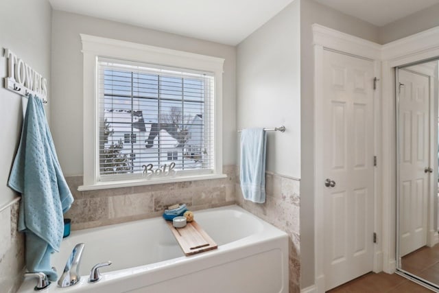 bathroom featuring a bathtub and tile patterned floors