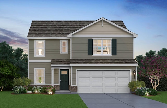 view of front of property with a garage, concrete driveway, roof with shingles, and a front yard