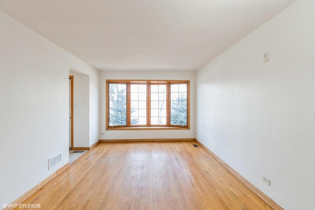 spare room featuring light hardwood / wood-style floors