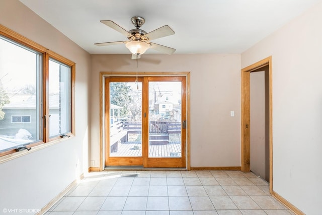 doorway featuring light tile patterned floors and ceiling fan