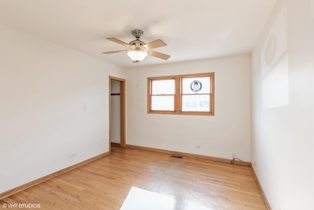 spare room featuring ceiling fan and light wood-type flooring