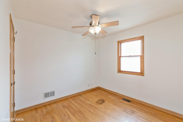 spare room featuring hardwood / wood-style flooring and ceiling fan