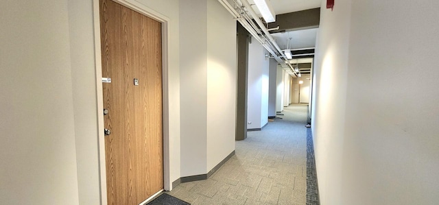 hall with light floors and baseboards