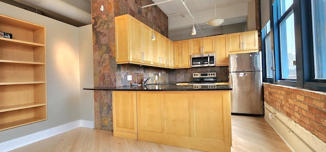 kitchen featuring a peninsula, open shelves, stainless steel appliances, and light brown cabinetry