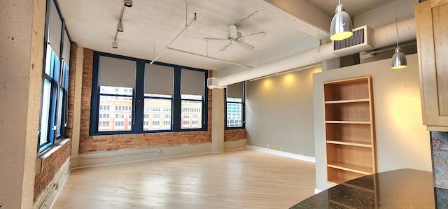 empty room featuring visible vents, baseboards, ceiling fan, rail lighting, and light wood-type flooring