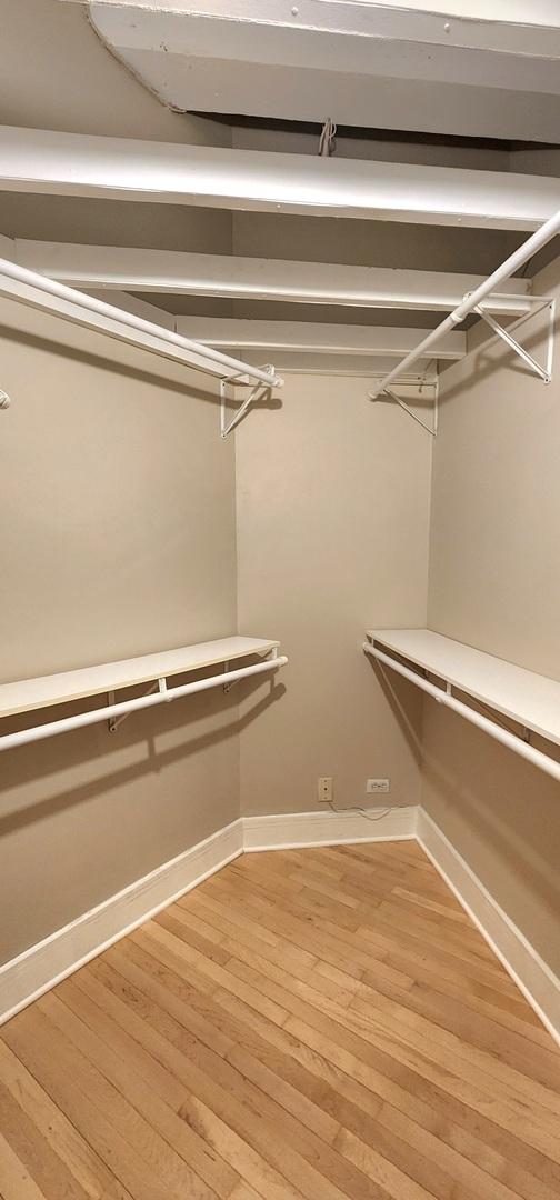 spacious closet with wood finished floors