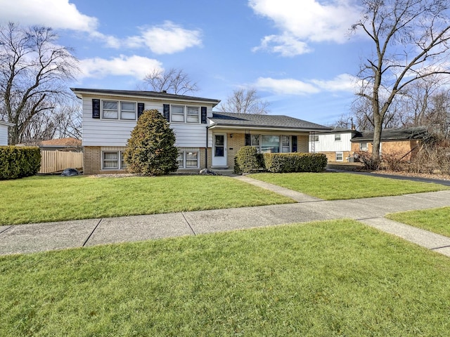 tri-level home with a front lawn