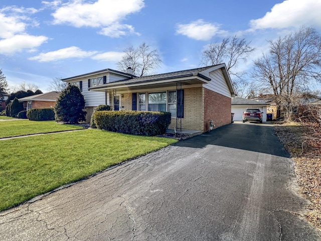 split level home featuring a garage and a front lawn