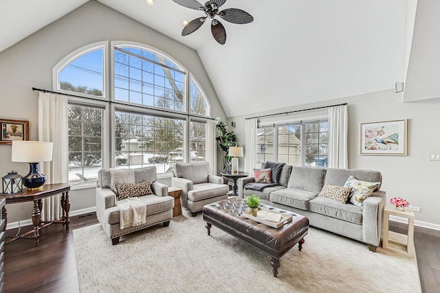 living room with high vaulted ceiling, wood finished floors, a wealth of natural light, and a ceiling fan