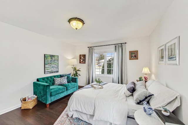 bedroom featuring dark wood-style floors and baseboards