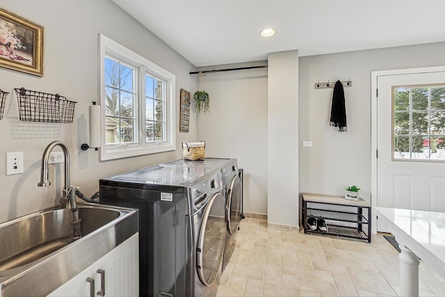 laundry room with recessed lighting, laundry area, a sink, baseboards, and independent washer and dryer