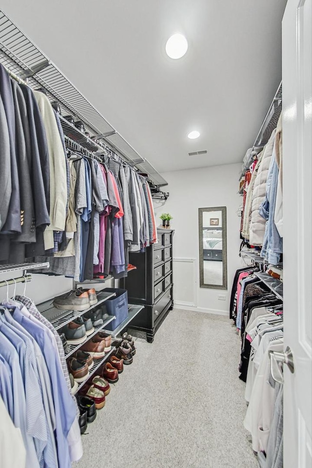 spacious closet featuring visible vents and light colored carpet