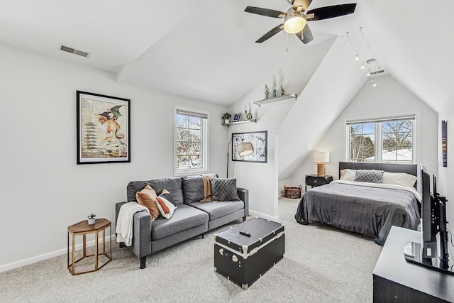 bedroom featuring vaulted ceiling, multiple windows, carpet, and visible vents